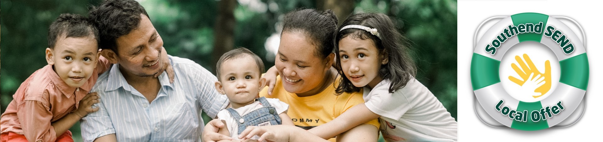 A family of Asian origin, there are of five of them sitting outdoors. The mother and father are carrying a toddler and there are other two small children next to each of them, with Local Offer logo on the right hand side.