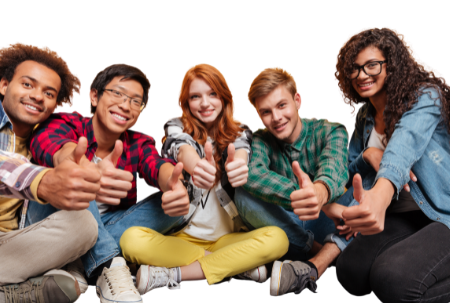 A group of five young people. They are looking at the camera smiling and they have their thumbs up.