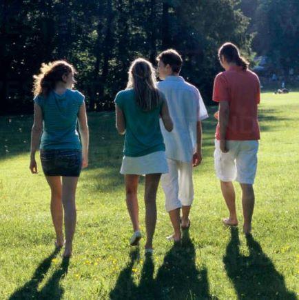 Four young people walking