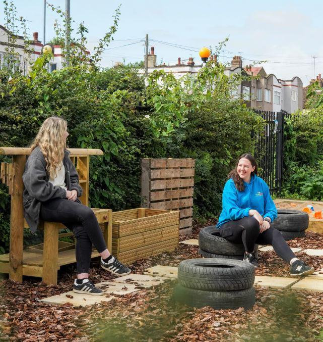 Two women sitting in a planting garden