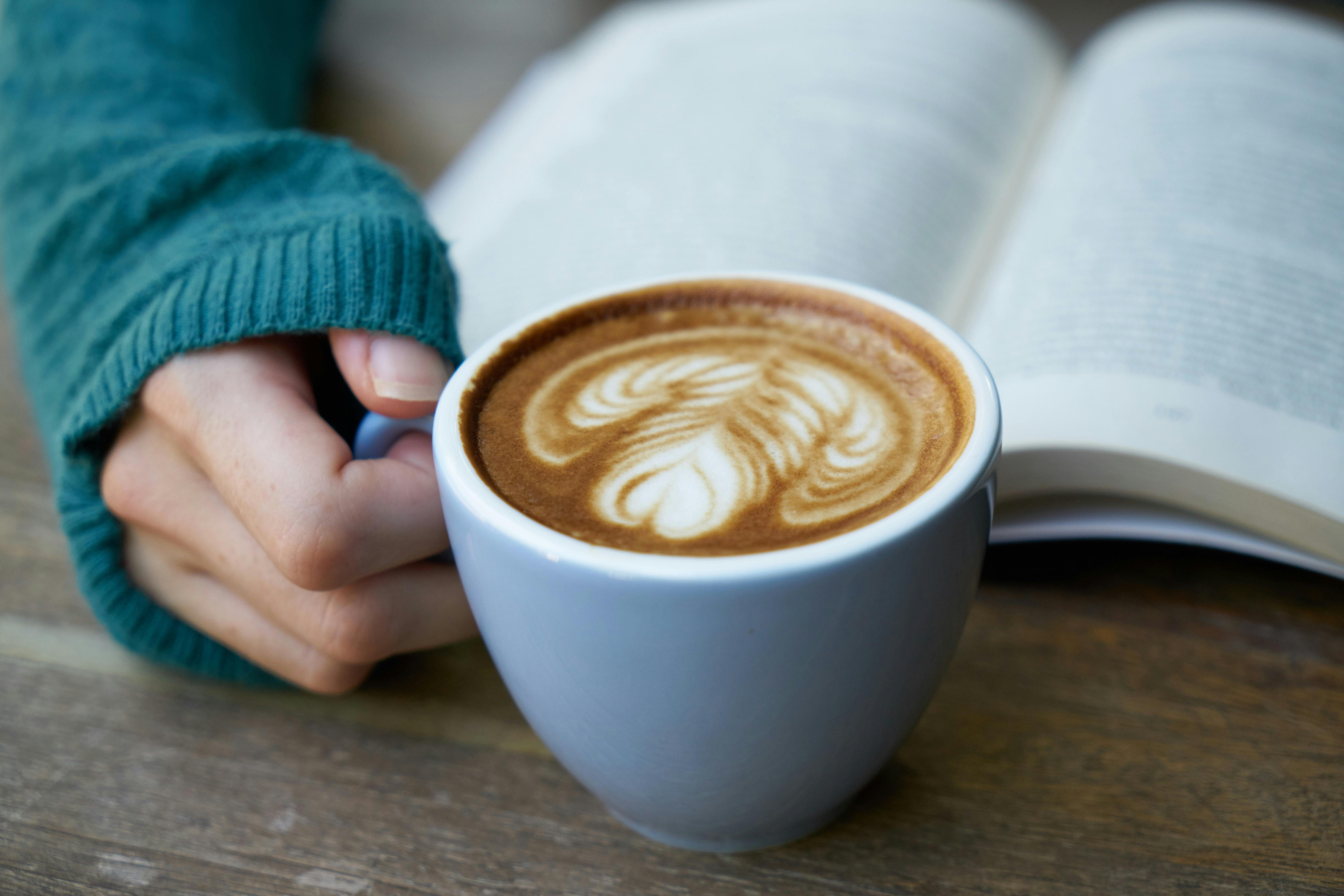 Hand holding a cup of coffee