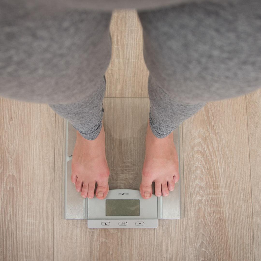 Woman standing on digital scales. Picture is taken from waist height looking down
